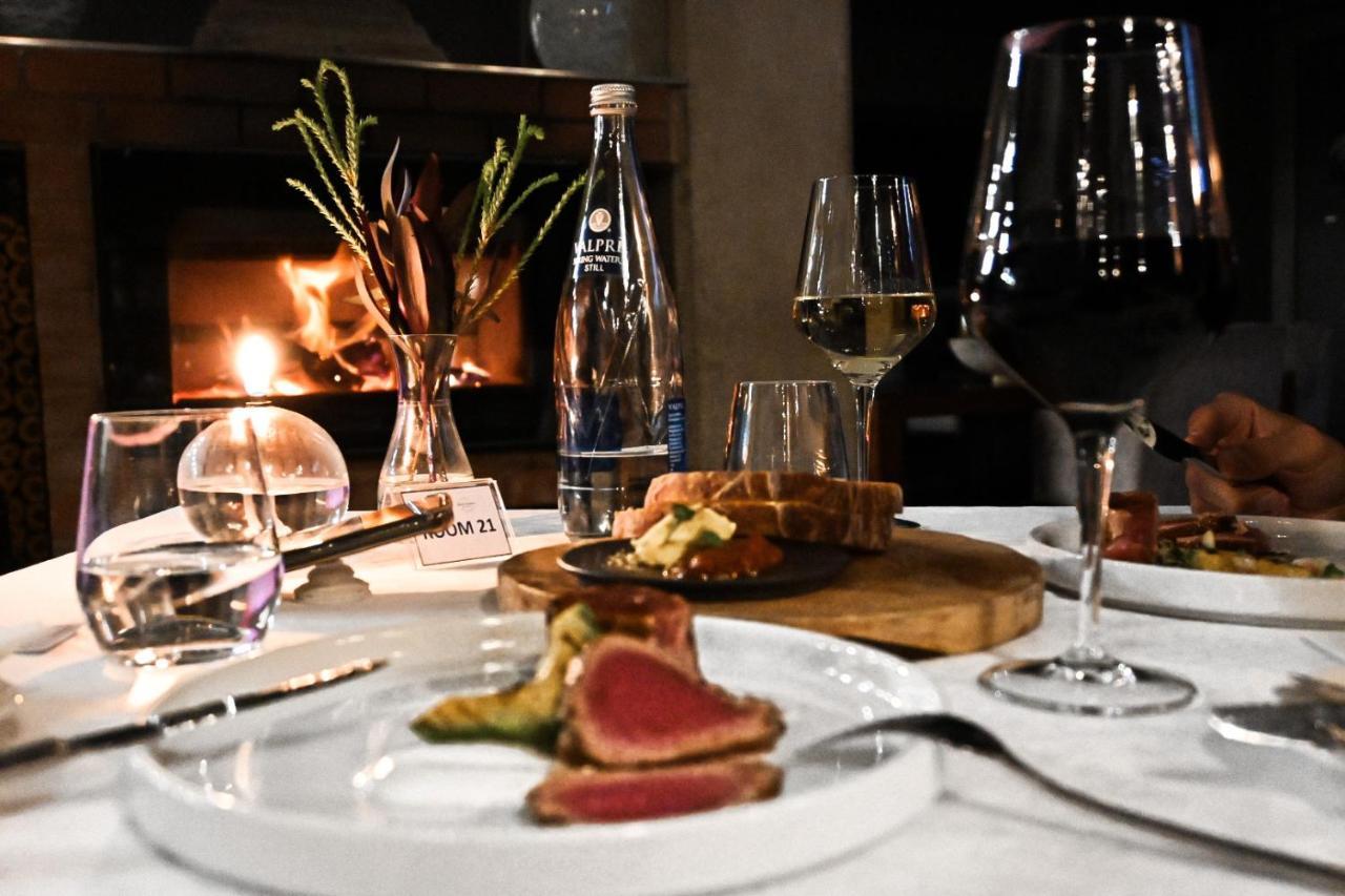 Menlyn Boutique Hotel Pretoria Exterior photo A dinner table with a fireplace